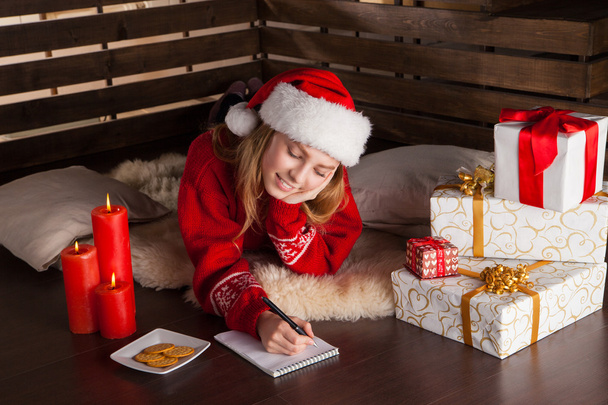 Happy young girl with Christmas presents - 写真・画像