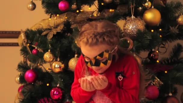 Little Girl in Mask Blowing Artificial Snow - Felvétel, videó