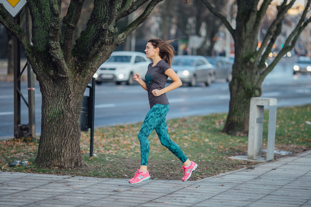 Young sport girl running in the park - Foto, imagen