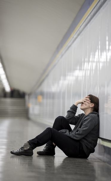 young sad woman in pain alone and depressed at urban subway tunn - Zdjęcie, obraz