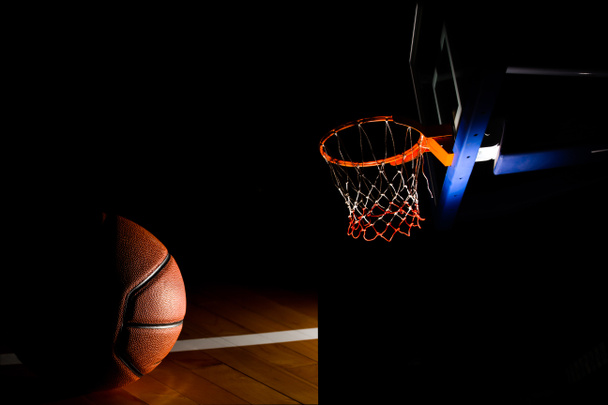 Basketball hoop on  black background with light effect - Foto, afbeelding