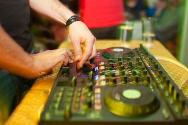 DJ Mixing music on console at the night club - Фото, изображение