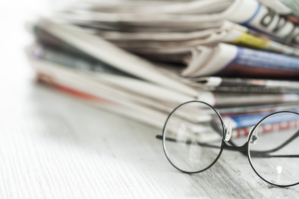 Stack of newspapers and eyeglasses - Photo, Image