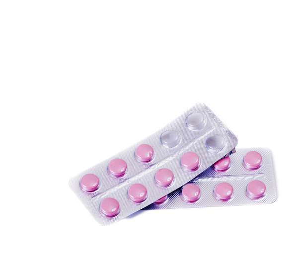 Vaaleanpunainen lääketieteellinen pillereitä valkoinen pöytä
 - Valokuva, kuva