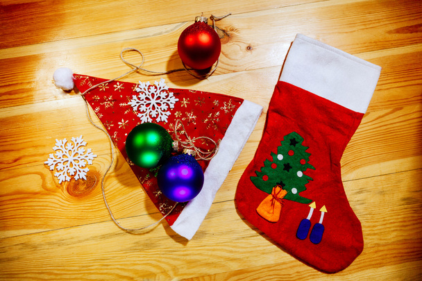 christmas socks and santa hat with balls snowflakes - Photo, Image