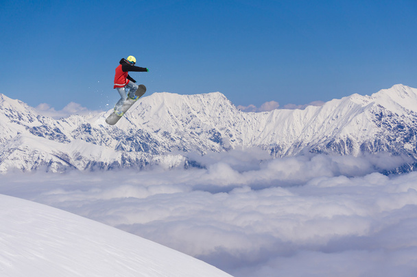 Flying snowboarder on mountains. Extreme sport. - Valokuva, kuva