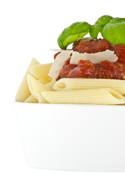 Penne in bowl decorated with fresh basil - Photo, Image