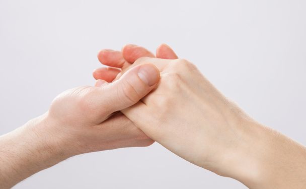 Man's hand holding woman's hand - 写真・画像