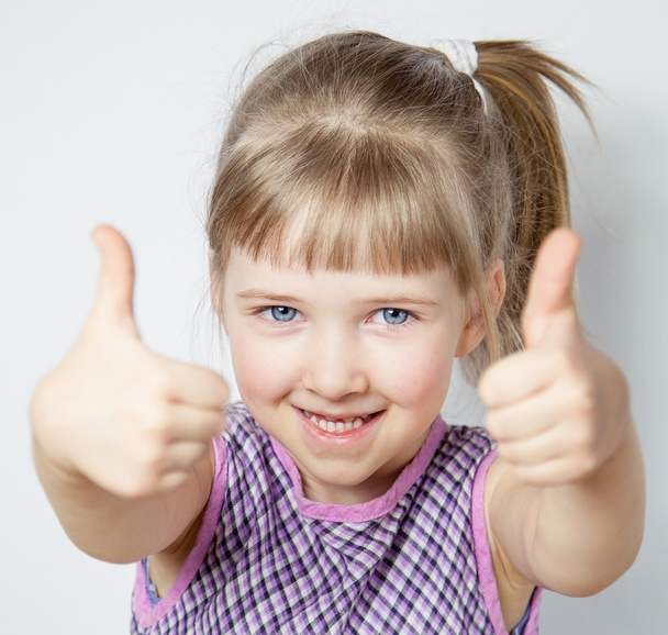 little girl showing thumbs up - Fotó, kép