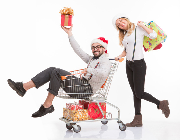 Happy man and woman with shopping cart - Foto, imagen