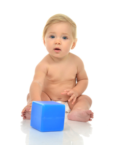 Infant child baby boy toddler playing holding blue brick toy in  - Photo, image