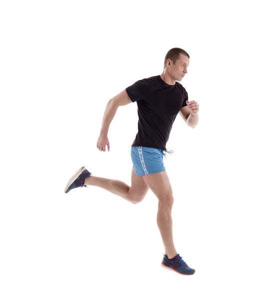 Side view of athlete running in studio - Foto, afbeelding