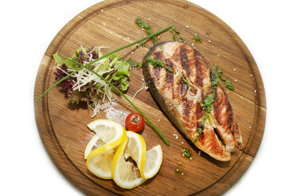Wooden plate with a piece of fish - Photo, Image