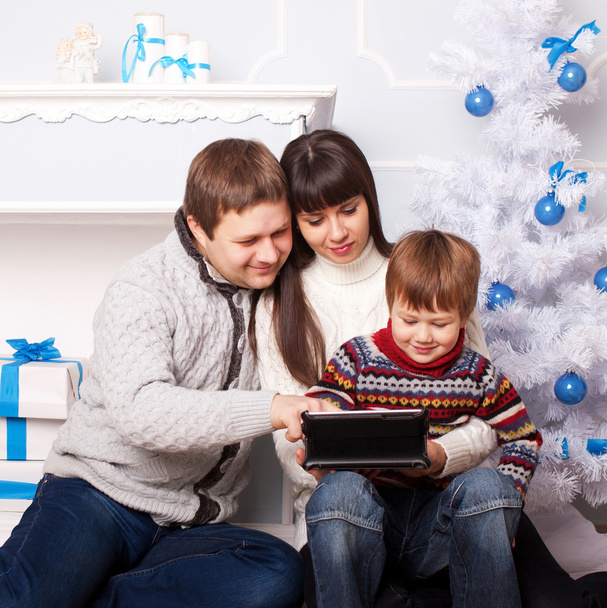 Family using tablet together on winter holidays  - Photo, Image