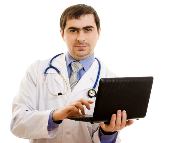 A man doctor consultant with a laptop on a white background. - Zdjęcie, obraz