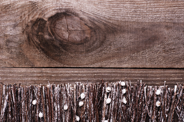Fence made from sticks, twigs, driftwood with white snowy paint on wooden background. Copy space. - Φωτογραφία, εικόνα