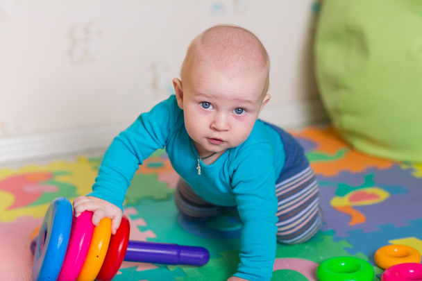 Cute little baby playing with colorful toys - Foto, Bild