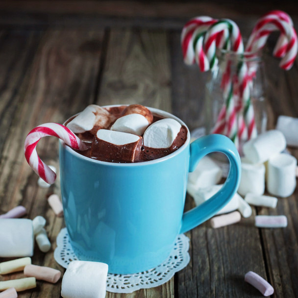 Mug filled with hot chocolate and marshmallow  and candy canes i - Photo, image