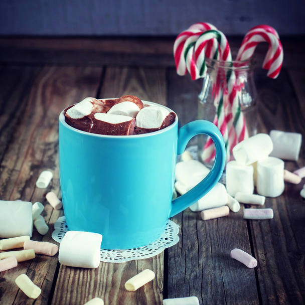 Mug filled with hot chocolate and marshmallow  and candy canes i - Фото, изображение