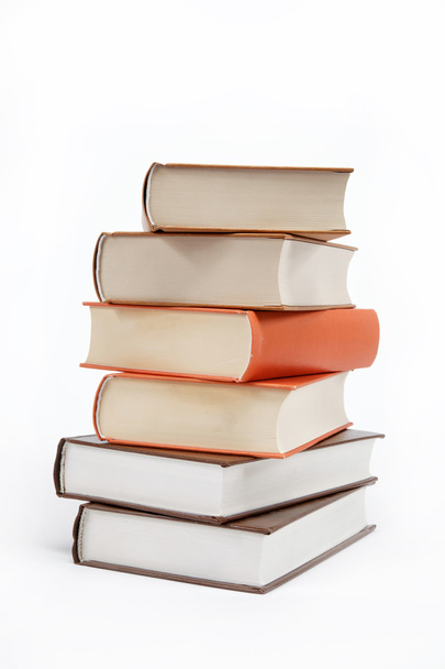 A stack of books on a white background. - Zdjęcie, obraz