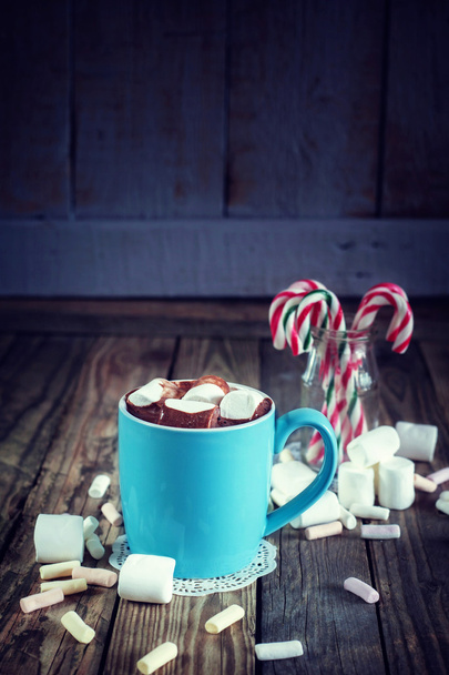 Mug filled with hot chocolate and marshmallow  and candy canes i - Fotó, kép