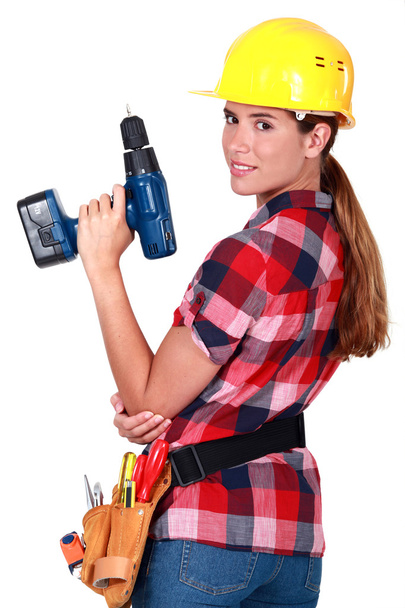 Profile of woman holding drill - Zdjęcie, obraz