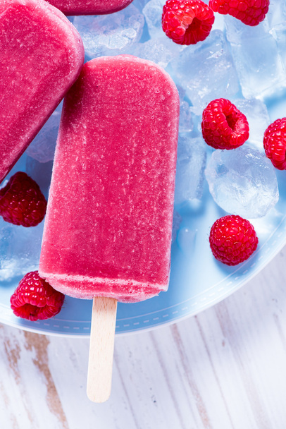 Homemade raspberry popsicles on plate - Photo, Image