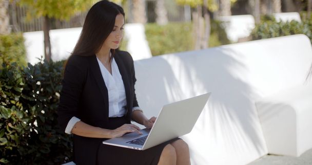 businesswoman working on park bench - Photo, Image