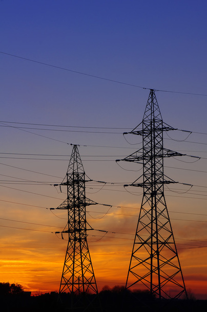 Electricity Pylon over orange sunset sky - Foto, Imagem