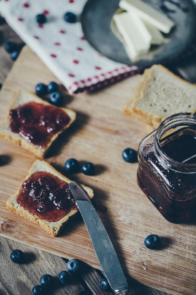 Toast bread with wild strawberry jam. Retro,vintage filter - Фото, изображение