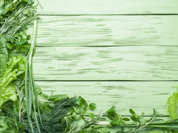 Green herbs on the green wooden background. - Foto, Imagem