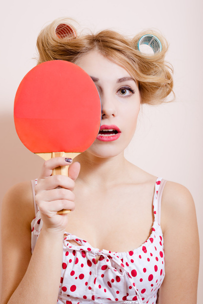 Pretty girl in dress and big curlers holding pingpong racket - Zdjęcie, obraz