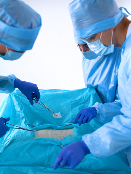 Equipo de cirujanos uniformados realiza la operación a un paciente en la clínica de cirugía cardíaca
 - Foto, imagen