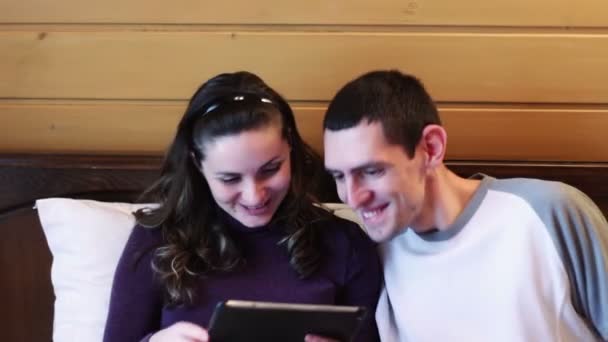 Happy Man and woman with the tablet on the bed. - Video, Çekim