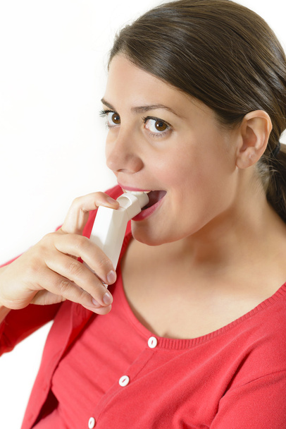 Woman using medicinal throat spray - Foto, afbeelding