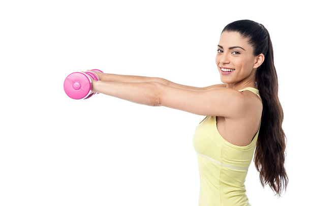 woman working out with dumbbells - Photo, image