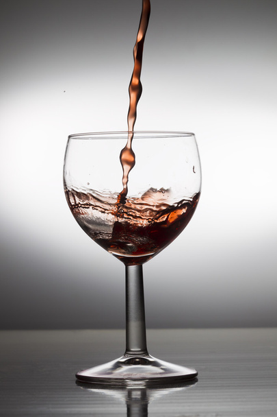 Wine pouring into a glass - Fotoğraf, Görsel