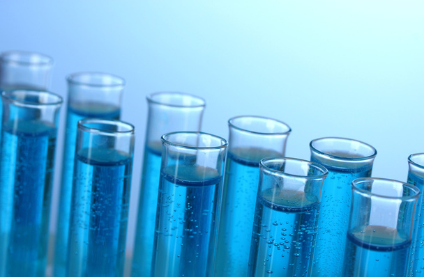 Test-tubes with blue liquid on blue background - Photo, Image