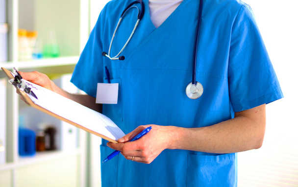 Closeup portrait of a  doctor with stethoscope holding folder - Photo, image