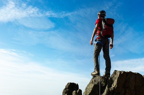 Climber arrive on the summit of a mountain peak. Concepts: victo - Photo, Image