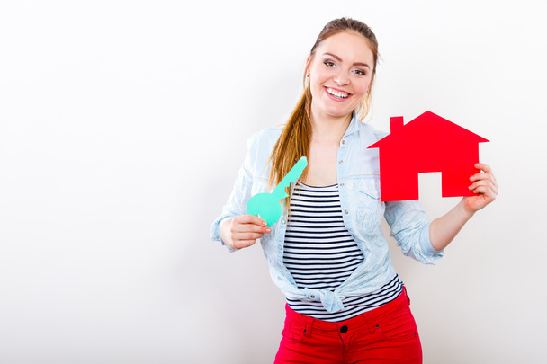 Woman and paper house. Housing real estate concept - Photo, Image