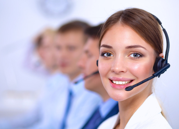 Attractive Smiling positive young businesspeople and colleagues in a call center office - Foto, afbeelding