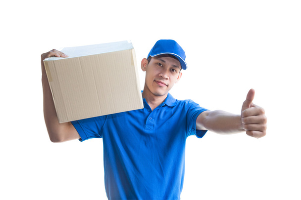 Asian delivery man carrying a parcel box and giving thumbs up - Photo, image