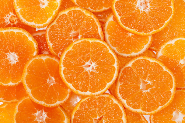 υπόβαθρο των φετών του clementine φρούτων. - Φωτογραφία, εικόνα