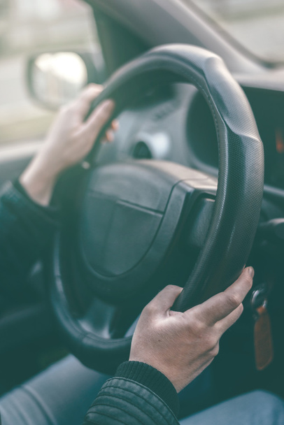 Female driver hands griping steering wheel - Foto, afbeelding