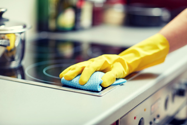 close up of woman cleaning cooker at home kitchen - Valokuva, kuva