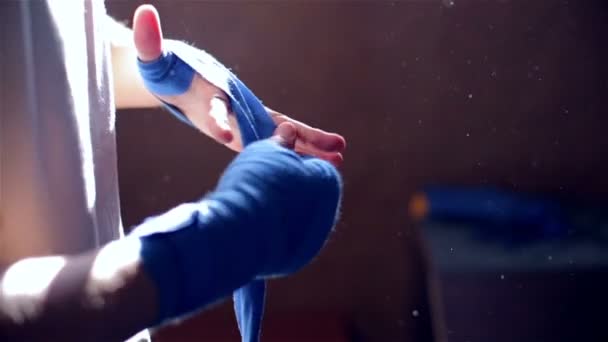 Man pulls bandage on his hands - Materiał filmowy, wideo