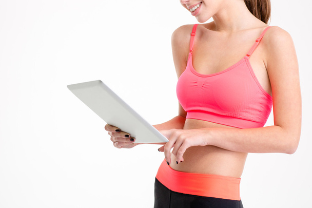 Tablet used by slim beautiful young sportswoman  - Zdjęcie, obraz
