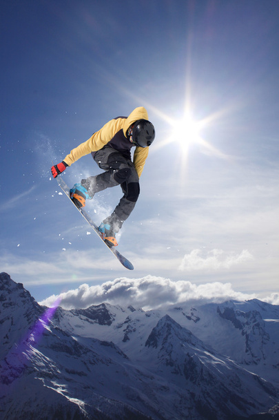 Flying snowboarder on mountains. Extreme sport. - Фото, зображення