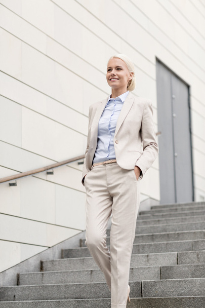 young smiling businesswoman walking down stairs - Photo, image
